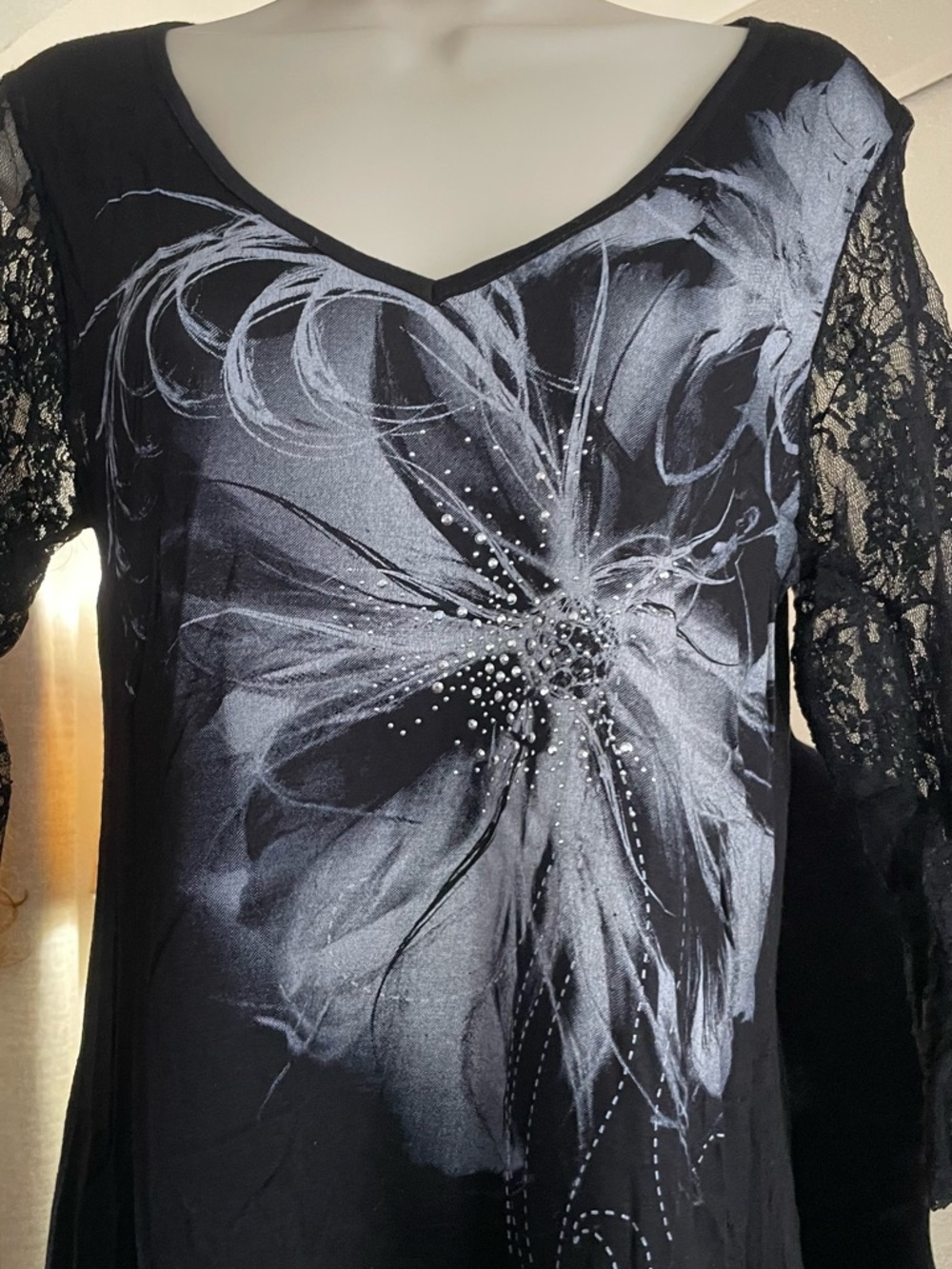 Lavish Black V-Neck Top with Floral Logo Accent